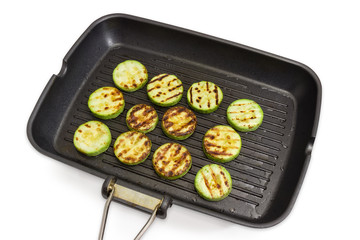 Grilled chopped by circles vegetable marrows on grill pan