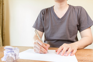 man writing with pen