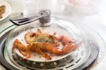 The prawns being cooked in the pan, the food background.