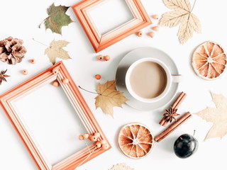 Autumn composition. Cup of coffee, empty wooden frame, dried leaves, cinnamon, star anise, cones, light background. Autumn elegant concept. Flat lay, top view, copy space 