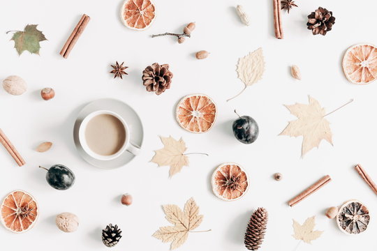 Autumn composition. Cup of coffee, dried leaves, cinnamon, star anise, cones, light background. Autumn elegant concept. Flat lay, top view, copy space 