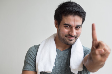 confident fitness man pointing up one finger; portrait of happy, healthy, confident, friendly...