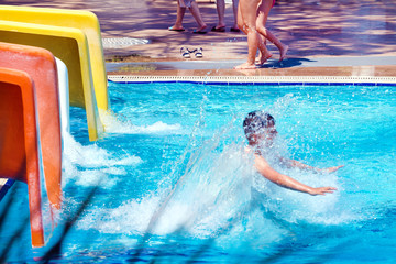 young boy having fun in aqua park