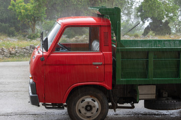 Red little truck in rain