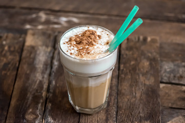 Cup of Coffee with Cream on Wooden Background