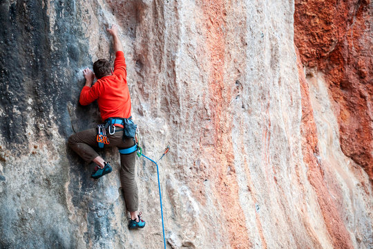 A man climbs the rock.