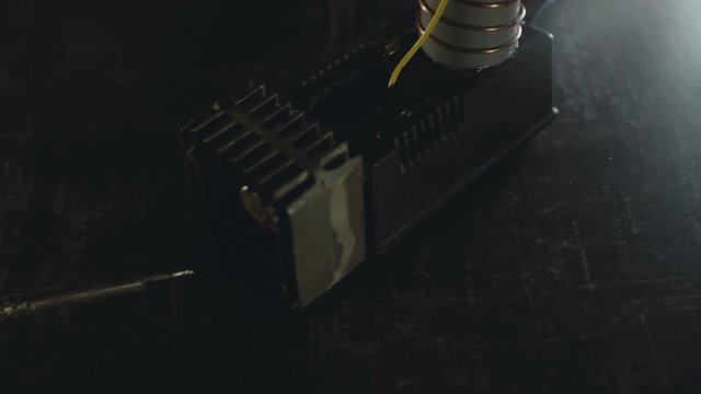 The prothesis hand catches the soldering iron on background