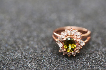 green gem stone and diamond on gold ring