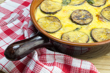 Moussaka casserole in clay serving dish close up