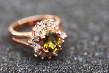 green gem stone and diamond on gold ring