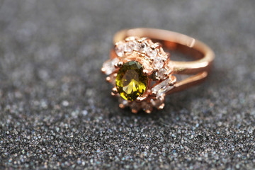 green gem stone and diamond on gold ring