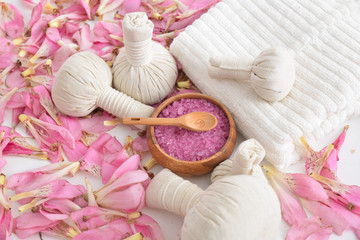 Obraz na płótnie Canvas Pile of many pink petals background with and herbal,salt, spoon in bowl, towel