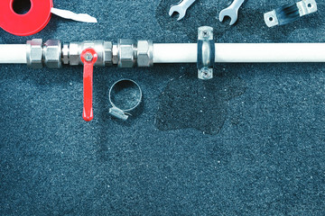Repair plumbing background.Fittings and tools on grey surface.
