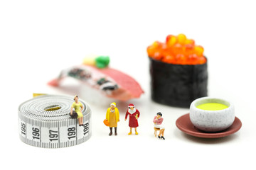 Miniature people : beautiful woman and doctor  with tape Measure of food diet,Healthcare and diet concept.