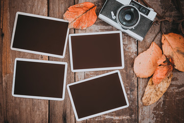 Retro camera with paper photo frame for add picture. memories and nostalgia in fall (Autumn)...