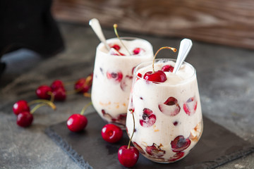 Homemade trifle pudding with freshcherry on dark background