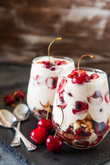 Homemade trifle pudding with freshcherry on dark background
