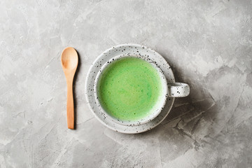 Matcha latte in white cup close up
