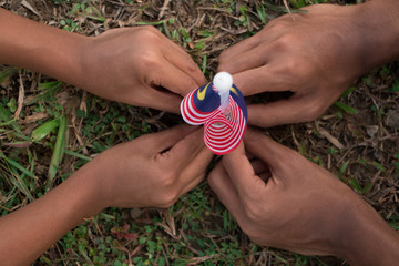 Independence Day concept. Kids' hands holding Malaysian flag.