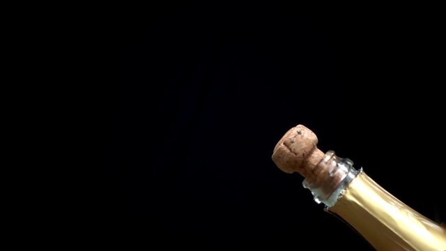 a champagne cork is popping out in slow motion