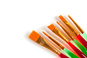 Paint brushes of various shapes and widths with bright plastic handles