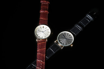 Men's accessories with brown leather wallet, belt and watch.
