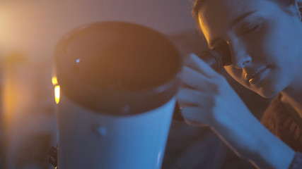Woman stargazing with a professional telescope