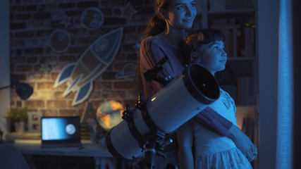 Loving mother and daughter watching stars together