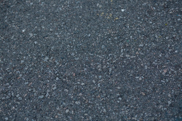 Closeup shot of a dark grey asphalt texture