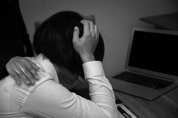 Businesswoman sitting stress within the office. She felt depressed and sad because the severest...