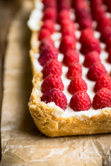 Fresh raspberry cheesecake on the rustic background. Selective focus. Shallow depth of field.