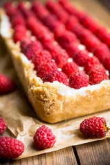 Fresh raspberry cheesecake on the rustic background. Selective focus. Shallow depth of field.