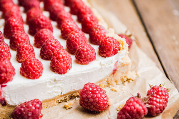 Fresh raspberry cheesecake on the rustic background. Selective focus. Shallow depth of field.