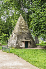 Fototapeta na wymiar Well preserved Egyptian Pyramid (1778) in Parc Monceau. Beautiful Parc Monceau (1778) - Public Park located in the 8th arrondissement of Paris, France.