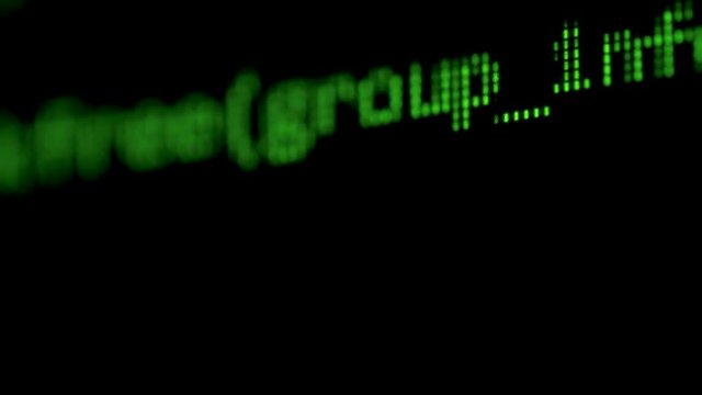 Green letters go on a monitor, close up.