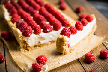 Fresh raspberry cheesecake on the rustic background. Selective focus. Shallow depth of field.