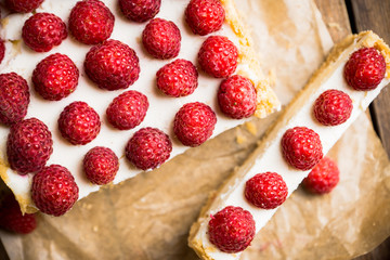 Fresh raspberry cheesecake on the rustic background. Selective focus. Shallow depth of field.