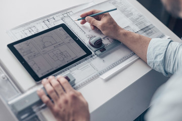 Men's hands with architectural tools