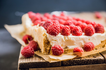 Fresh raspberry cheesecake on the rustic background. Selective focus. Shallow depth of field.