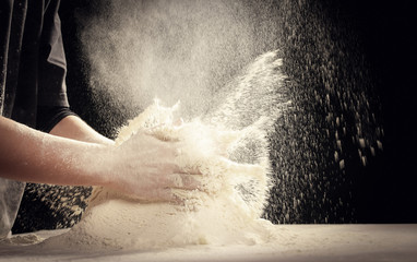 Making dough by female hands at home in kitchen