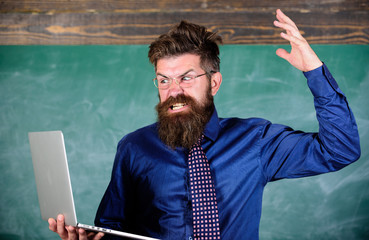 Can not get used to modern technology. Teacher bearded man with modern laptop chalkboard...