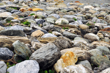 Fototapeta na wymiar Nice scenery at Taiwan seaside with big rocks and pebbles, cloudy blue sky