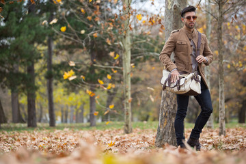 Young adult man handsome posing in the wood, winter autumn day