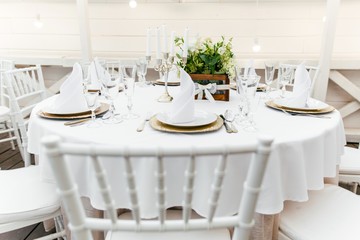 Table setting on a white tablecloth in the restaurant