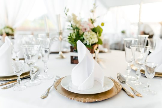 Table setting on a white tablecloth in the restaurant close-up