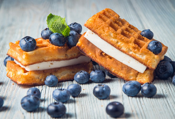 waffles with fresh blueberry on wooden background