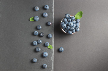 blueberry with mint on a stone background slate