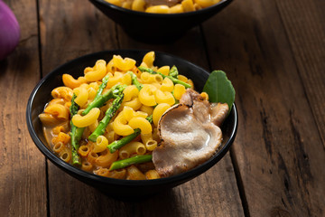 tom yam soup pasta on wood

