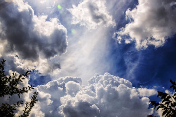 divine clouds on a blue sky view from a garden