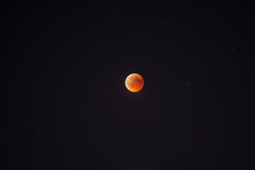 The  moon eclipse on the night sky.